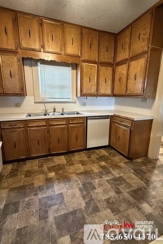 A kitchen with wooden cabinets and a checkered floor.