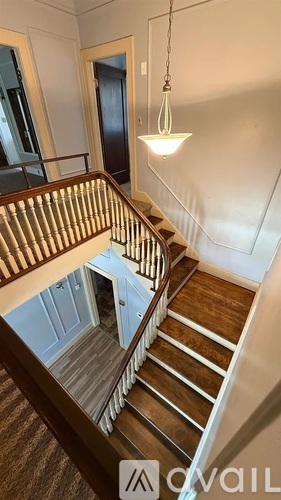 A staircase with a light hanging from the ceiling.