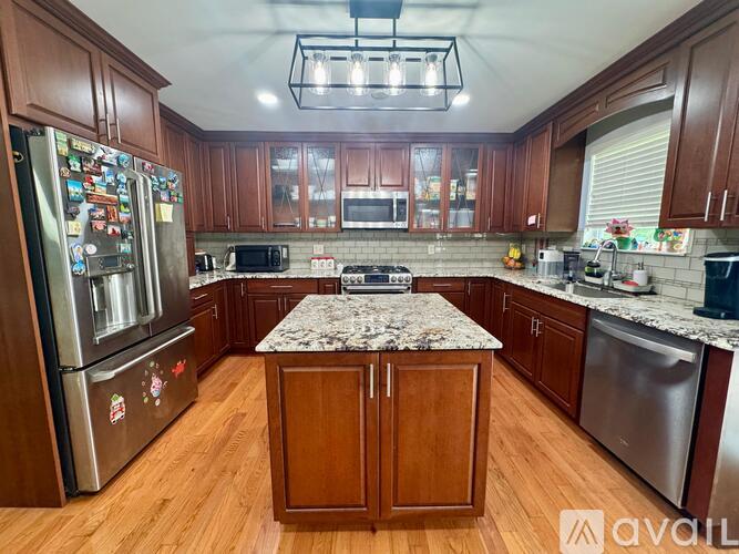A kitchen with wooden cabinets and a granite countertop.