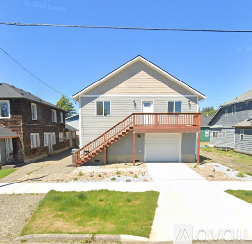 A house with a garage and a deck is for sale.