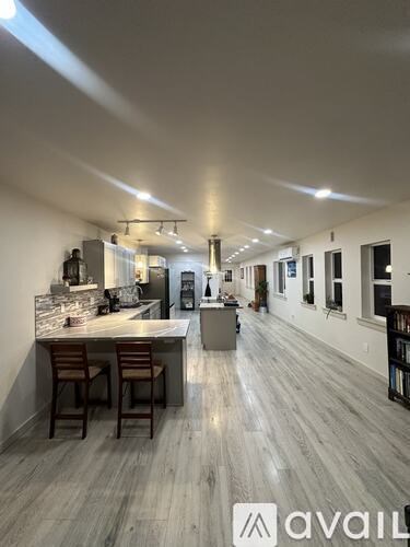 A modern kitchen with a bar area and a dining area.