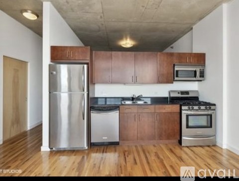 A kitchen with wooden cabinets and stainless steel appliances.