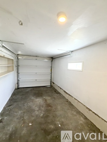 A garage with a white door and a window.