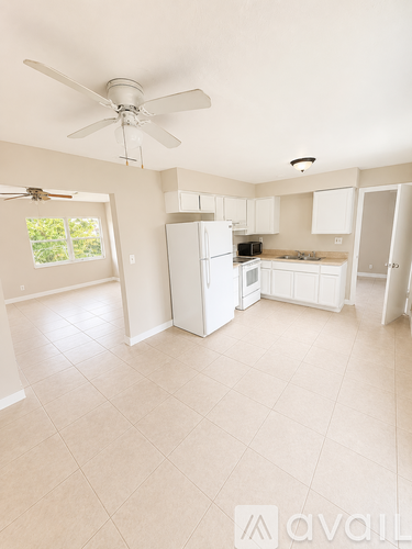 A kitchen with white appliances and cabinets.
