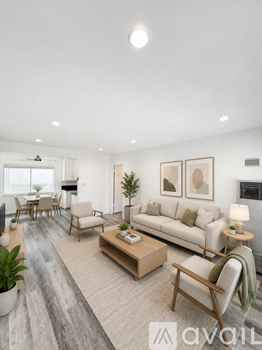 A living room with a couch, chairs, and a coffee table.
