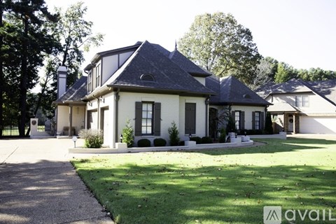 A large house with a driveway in front of it.