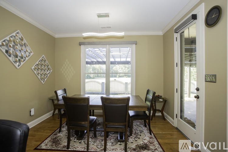 A dining room with a table set for six.