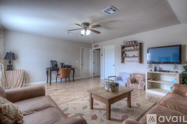 A living room with a brown couch and a wooden coffee table.