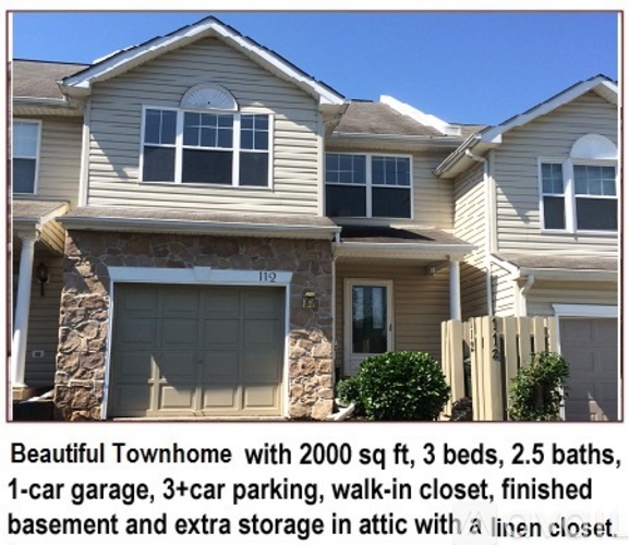 A large townhome with a garage and a walk-in closet.