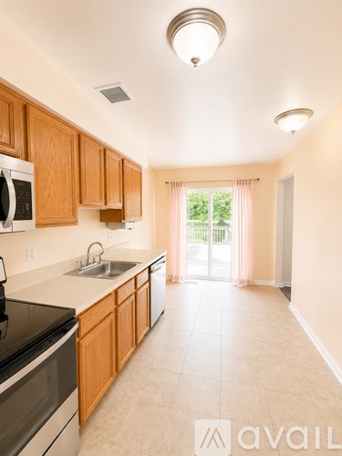 A kitchen with wooden cabinets and a black stove top oven.
