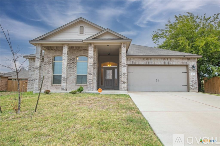 A two-story house with a garage and a driveway.