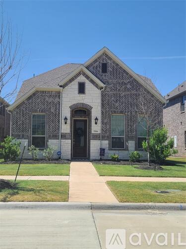 A house with a patterned facade and a front yard.