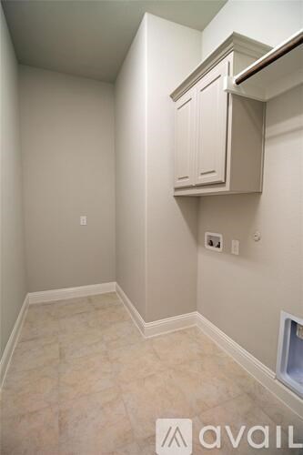 A kitchen area with a cabinet and a tile floor.