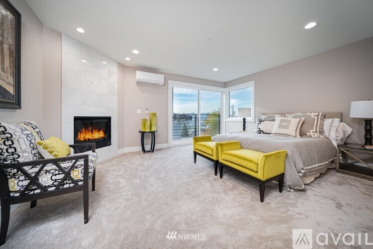 A bedroom with a fireplace and a large bed.