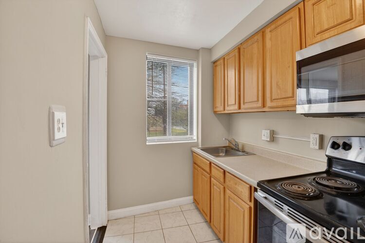 A kitchen with wooden cabinets and a black stove top oven.