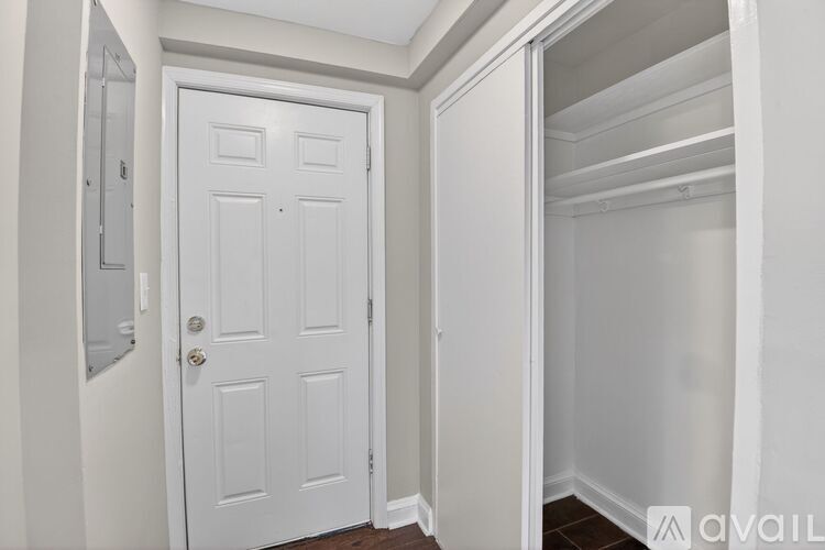 A white door is in a white room.