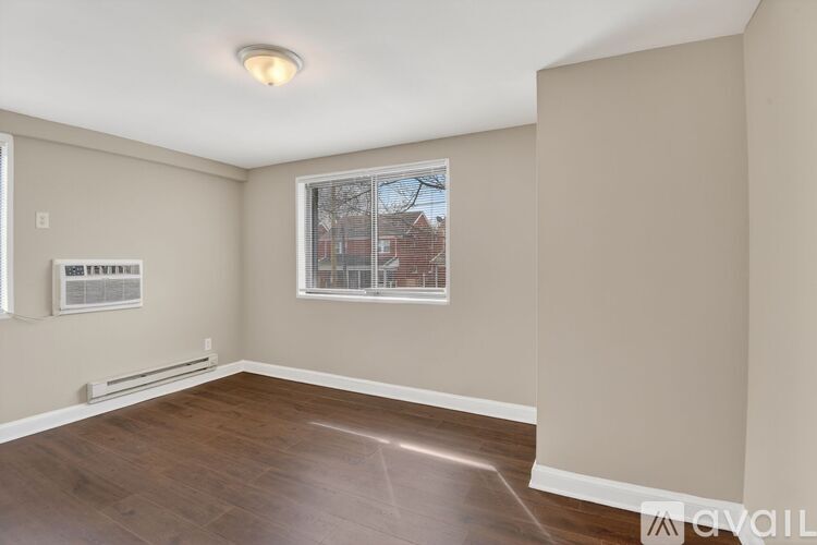 A room with a window and a view of a building outside.