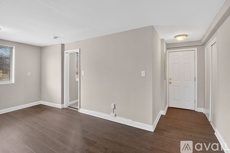 A room with wooden floors and white walls.