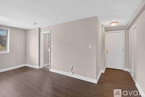 A room with wooden floors and white walls.