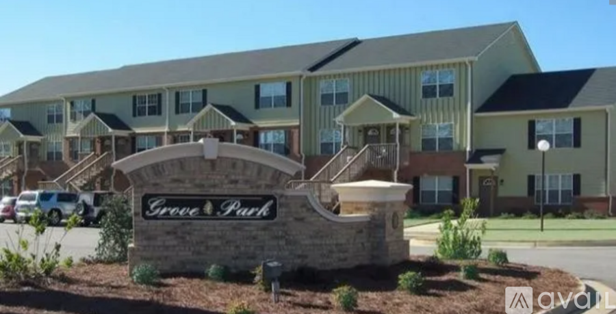 A building with a sign that says Grove Park in front of it.