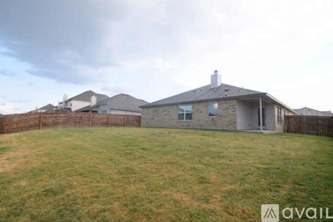 A house with a fence and a grassy yard is available for sale.