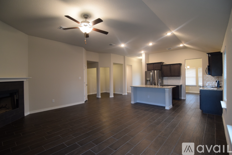 A spacious living room with a fireplace and a television.