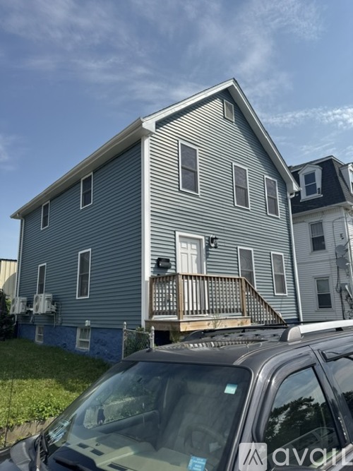 A house with a car parked in front of it.