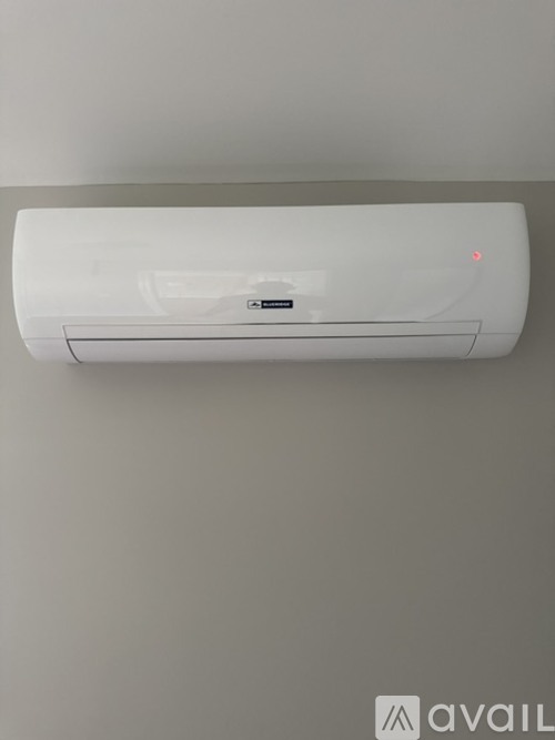 A wall-mounted air conditioner unit is installed on a wall.