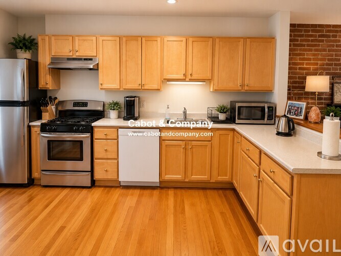 A kitchen with wooden cabinets and a white countertop.