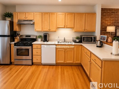 A kitchen with wooden cabinets and a white countertop.