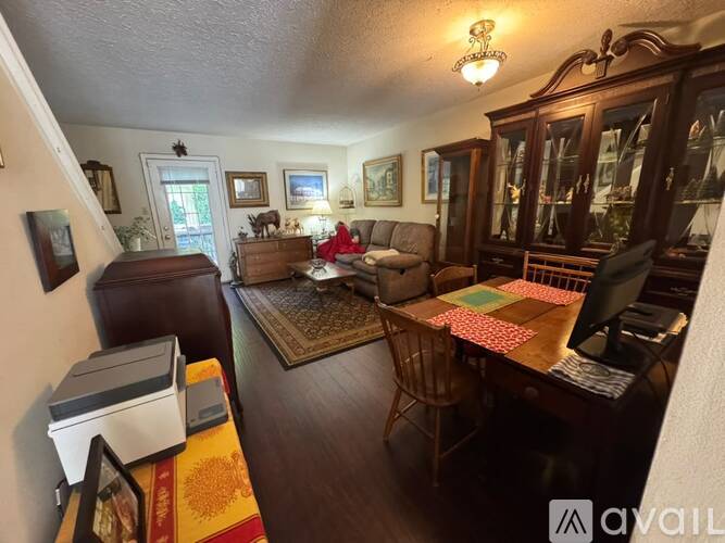 A living room with a couch, chair, and a coffee table.
