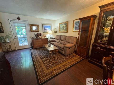 A living room with a couch, chair, and a coffee table.