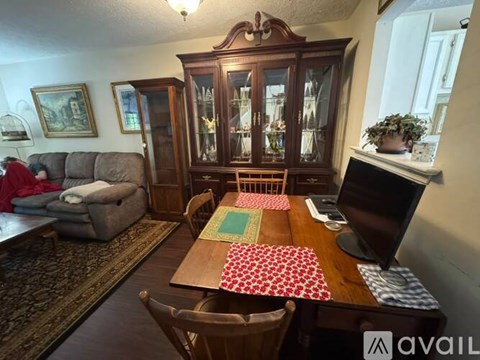 A dining room with a wooden table and chairs.