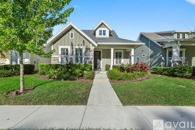 A house with a front yard and a tree.