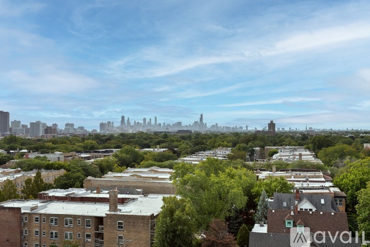 A cityscape with buildings and trees in the foreground.