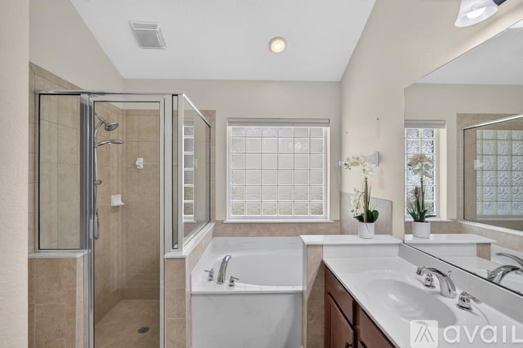 A bathroom with a tub, sink, and shower.