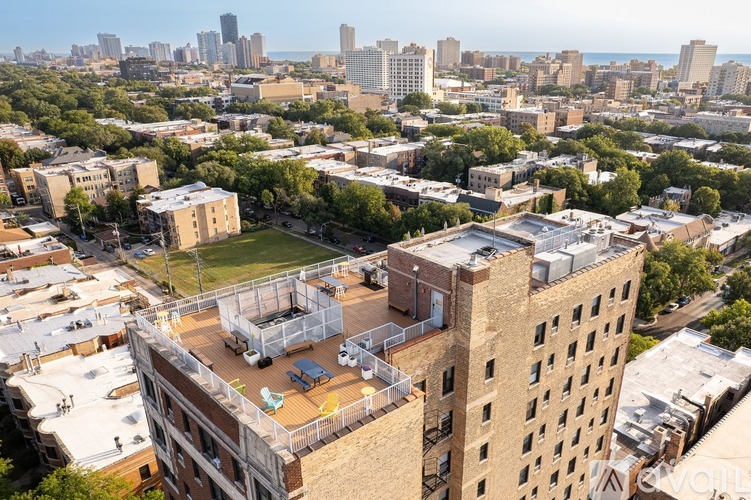A cityscape with a mix of modern and older buildings, with a clear sky above.