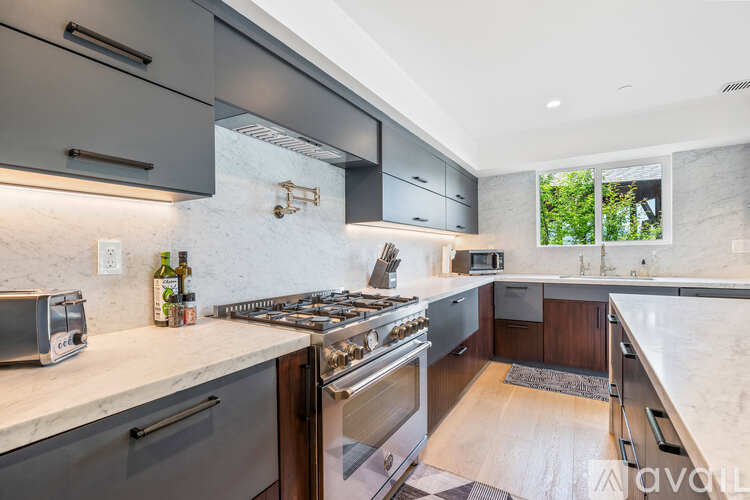 A modern kitchen with a stove top oven and a microwave.