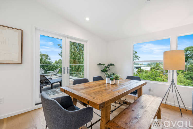 A dining room with a wooden table and chairs.
