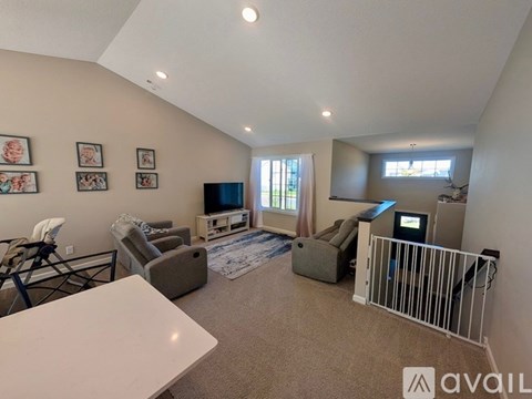 A living room with a white table and a television.