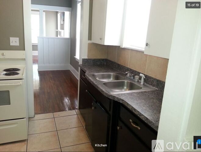 A kitchen with a white oven and black countertops.