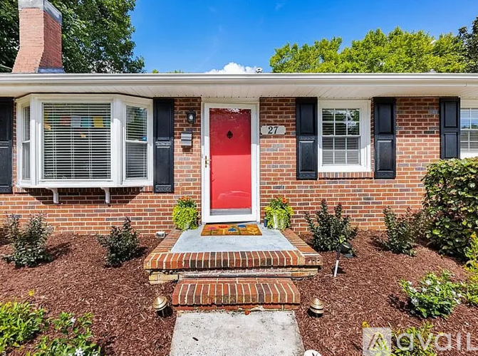 A red door with a number 27 on it is the focal point of this image.