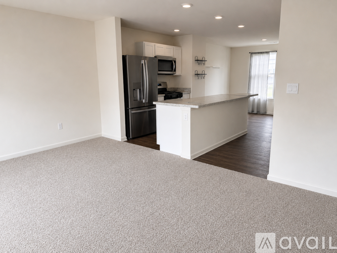 A spacious kitchen with a refrigerator, microwave, and oven.