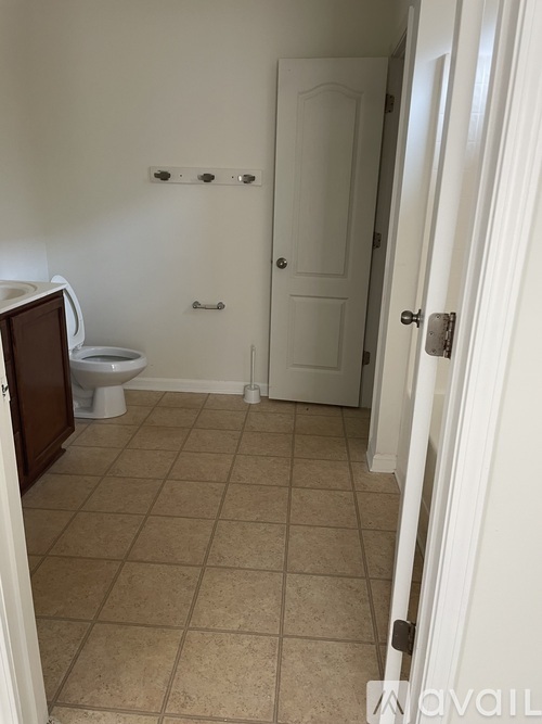 A bathroom with a toilet and a door.