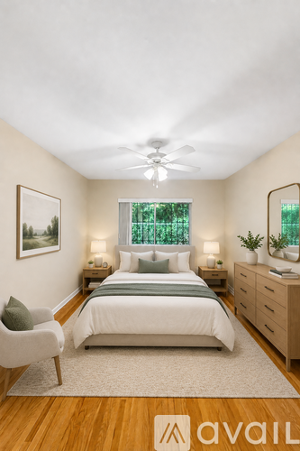 A bedroom with a bed, chair, and a ceiling fan.