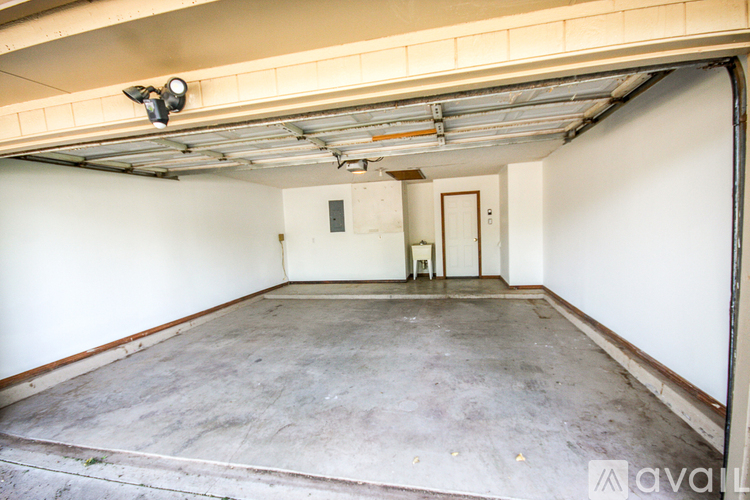 A spacious garage with a concrete floor and white walls.