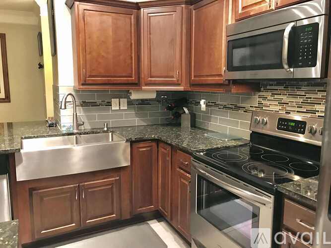 A kitchen with wooden cabinets and stainless steel appliances.