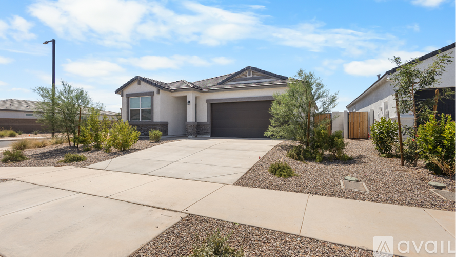 A house with a garage and a driveway in front of it.