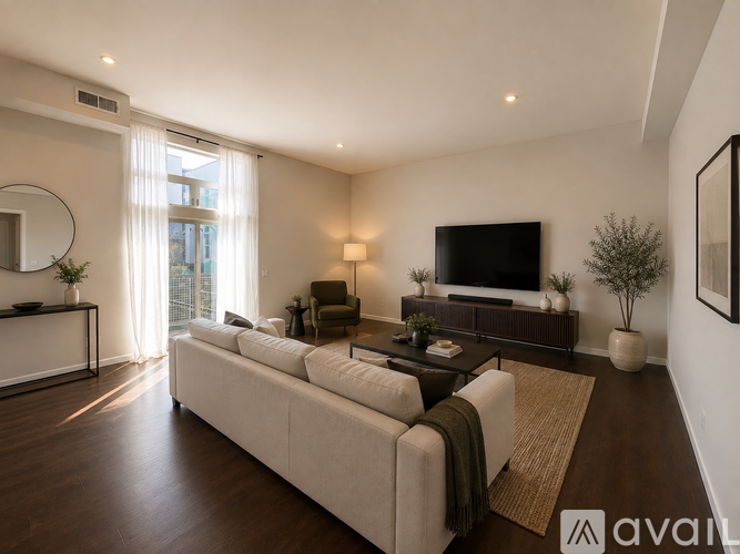 A modern living room with a large sectional sofa and a flat-screen TV.