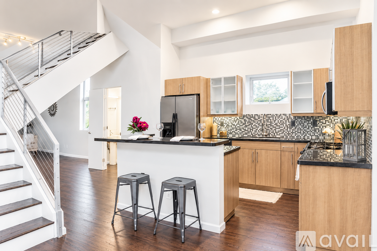 A kitchen with a bar stool and a counter top.